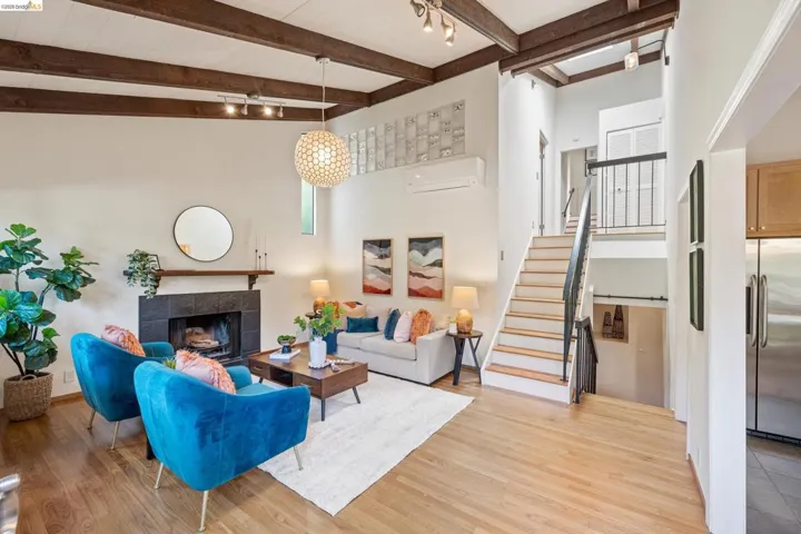 Living area featuring a fireplace, light wood-style floors, and track lighting