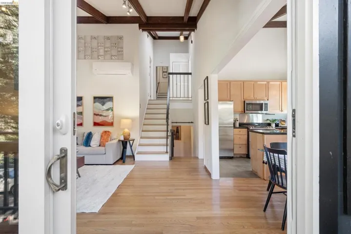 Entryway with light wood-style flooring and rail lighting