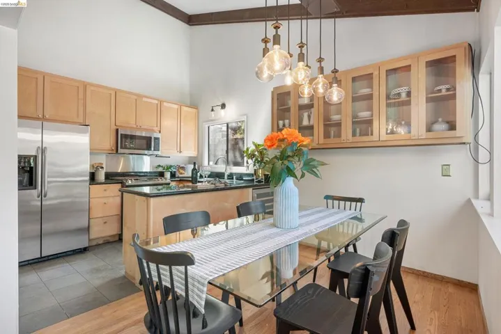 Dining room with light wood-style flooring and lofted ceiling