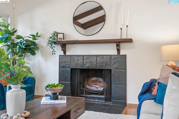 Detailed view of wood finished floors and a tile fireplace