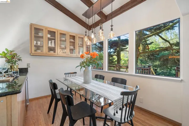 Dining room featuring light wood-type flooring and lofted ceiling