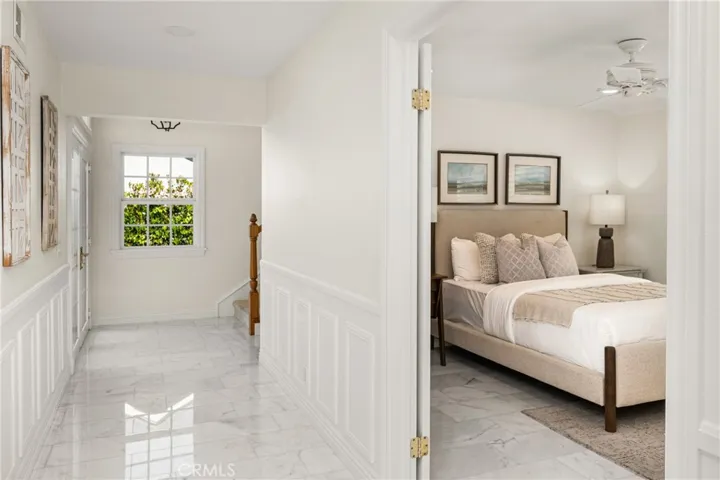  Double door entry into the downstairs bedroom with a ceiling fan.