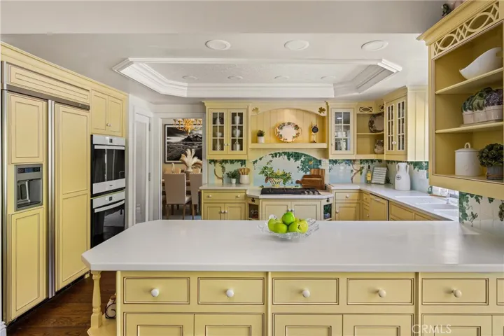 This kitchen is a chef's delight with a built-in refrigerator, new double ovens and a new gas cooktop! A large walk-in pantry is to the right of the ovens!