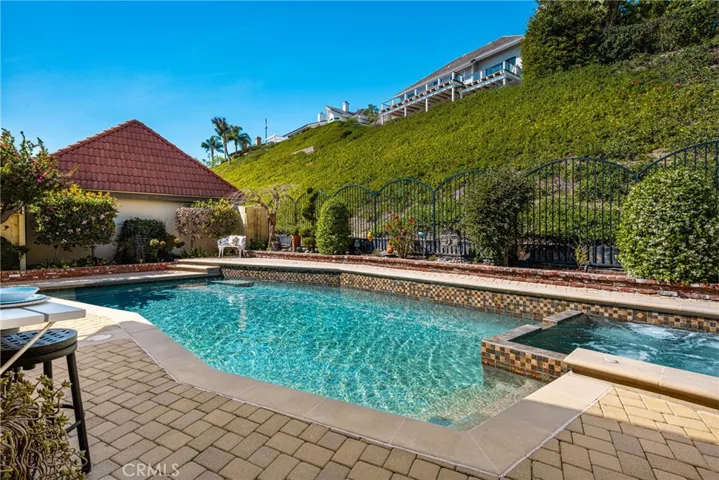 A lush, green slope provides the backdrop to your backyard oasis!