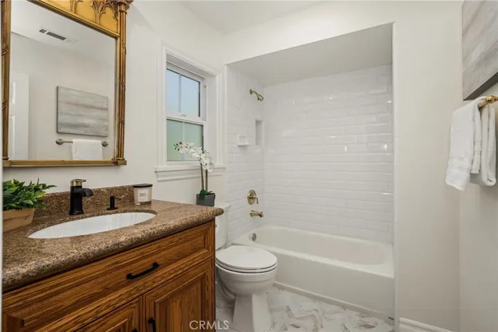 Updated full bath has granite counters and new tile flooring. Located right off of the bonus room, makes the space an optional, very large 6th bedroom!