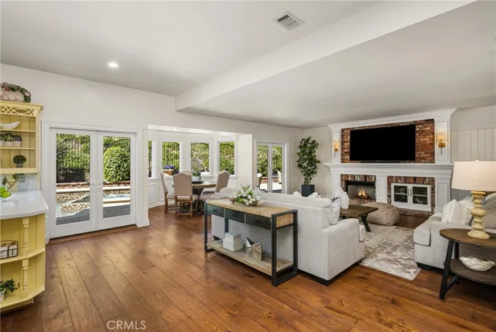 Family room/den area has two sets of French doors, that flood the room with light and open to your backyard with a pool & spa!
