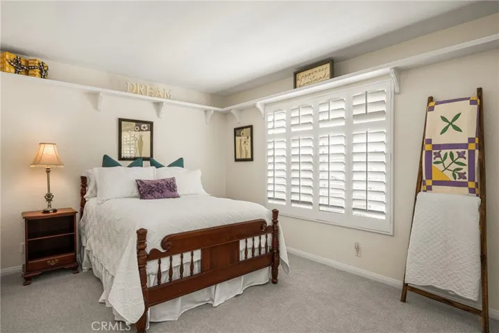 The corner bedroom is light and bright, offering new carpet & plantation shutters.