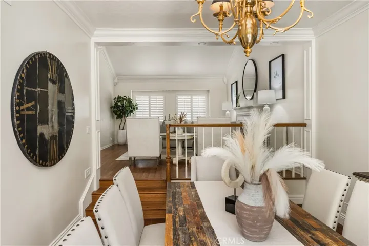 Open to the formal living space, the dining room has accents of custom woodwork and rich hardwood flooring.