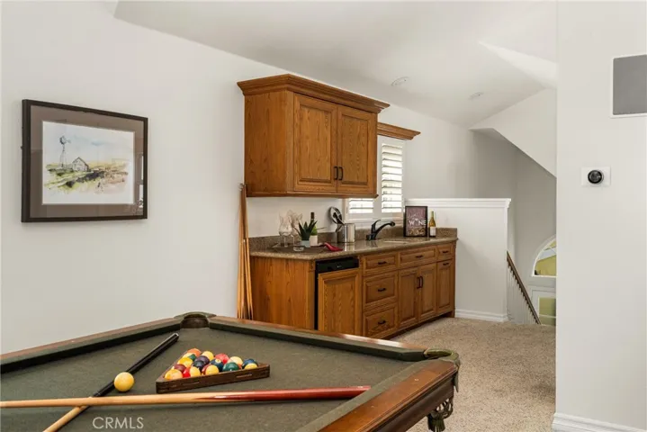 The bonus room features a mini kitchen with dishwasher, sink, disposal and storage - making it the perfect guest quarters or bonus room!