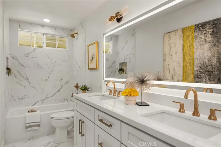 Beautifully remodeled upstairs hall bath features new floor and tub tile surround, new vanity & fixtures.