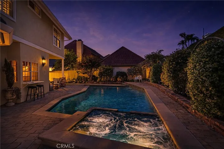 Just as inviting in the evening, enjoy the pool and spa in your private backyard!