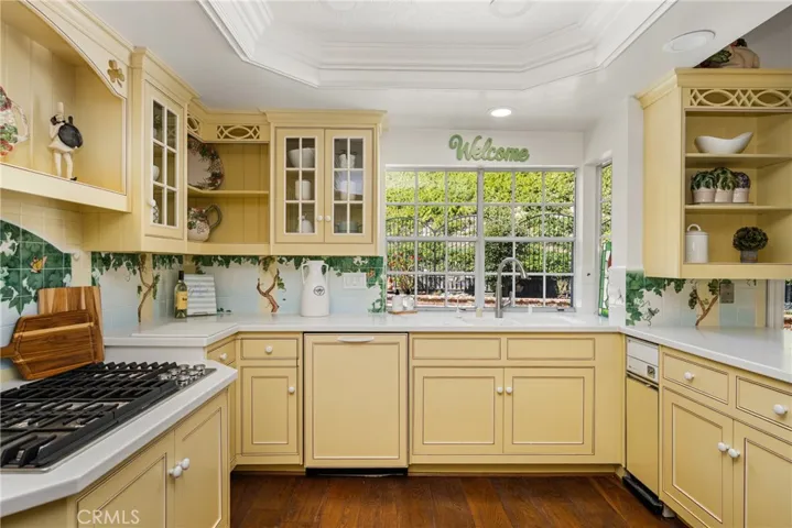 Recessed lighting, crown molding and pressed tin ceiling tiles add warmth and charm to this country kitchen.