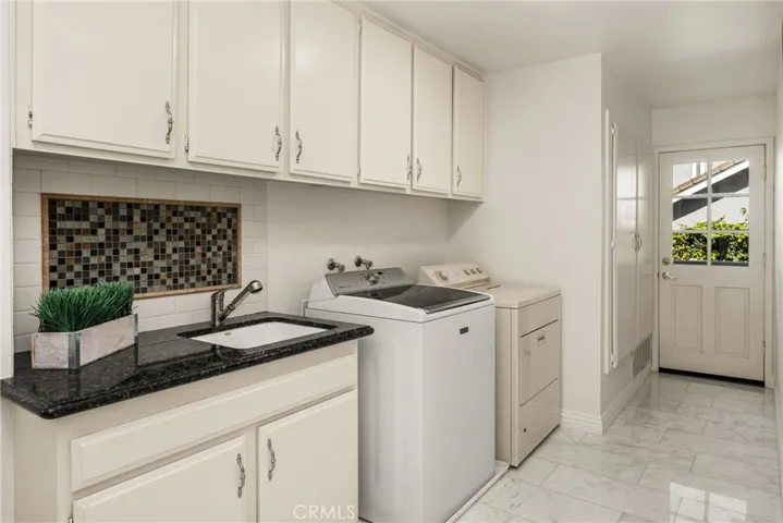 A door to the backyard in the laundry room offers easy access to the shower on those hot summer pool days!
