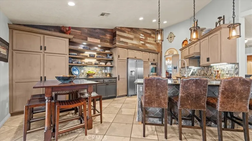 Kitchen with bar seating and adjacent dining area, offering everyday functionality and easy flow