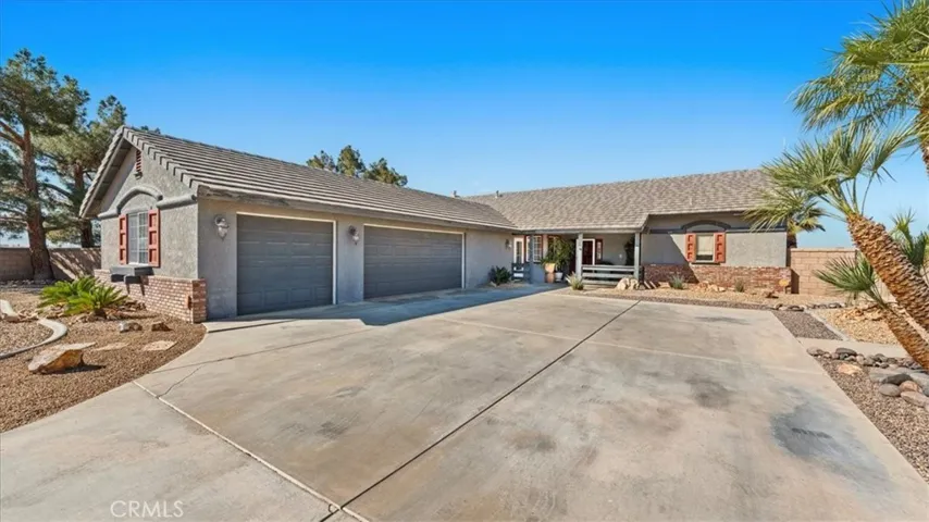 Front Exterior: Former model home situated on a half-acre corner lot with mature landscaping and clean curb appeal