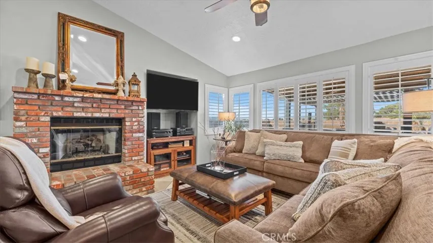 Living room: Open living area with natural light and travertine flooring