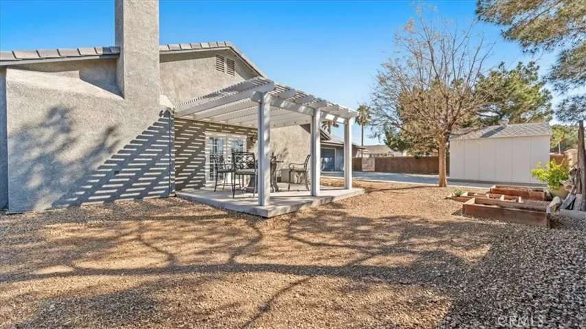 Covered patio with elevated deck area—ideal for outdoor dining and lounging