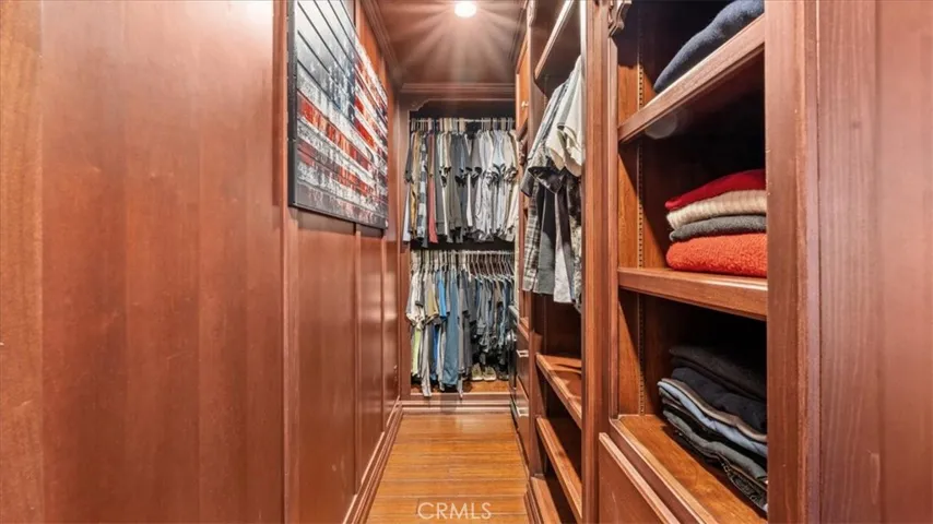 Inside one of the two custom cherry poplar walk-in closet systems