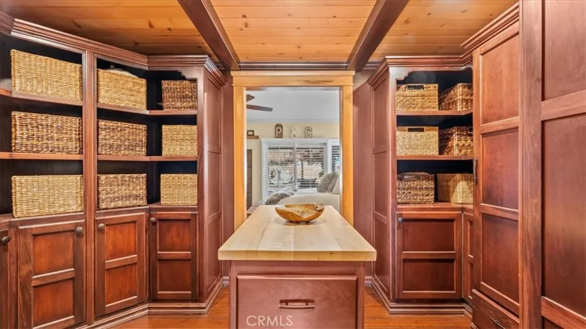 Larger custom cherry poplar walk-in closet system which leads into ensuite