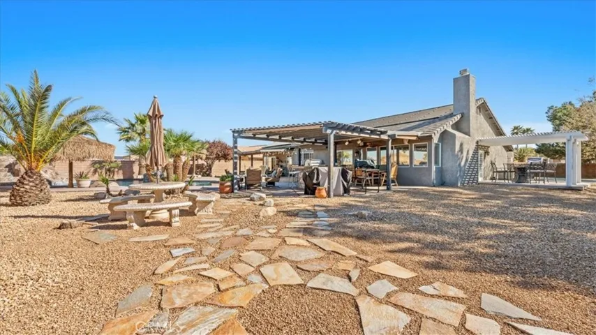 Another angle of Backyard wide shot: Multiple outdoor living spaces designed for hosting and relaxation