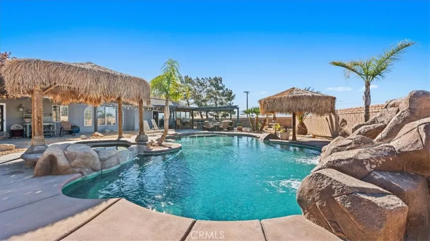 Saltwater pool and spa with rock waterfall and slide feature