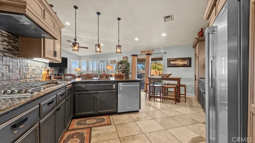 Opposite angle of kitchen showcasing High-end KitchenAid and Electrolux Icon appliances (included)