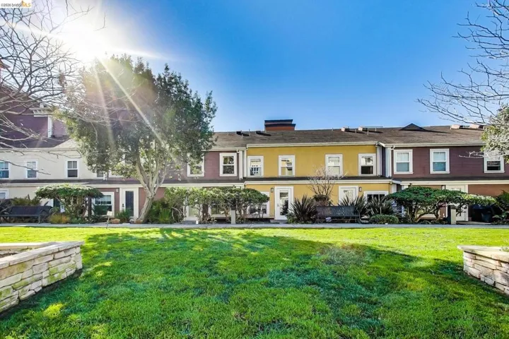 View of front facade featuring a front yard, a chimney, and stucco siding