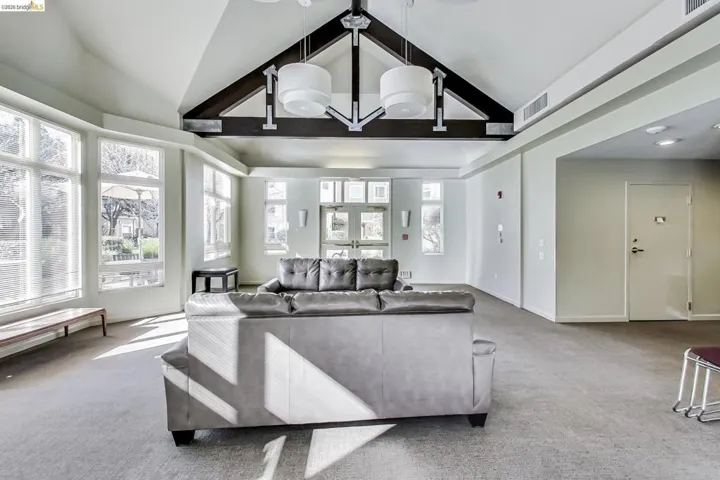 Living room featuring carpet floors and a high ceiling