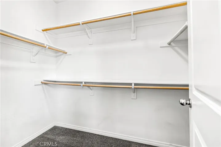 Walk-in closet at primary bedroom