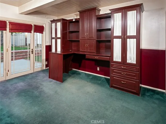 The main level features a desirable downstairs bedroom with direct patio and pool access through elegant French doors, ideal as a primary bedroom, guest retreat, space for extended family, or a private home office.