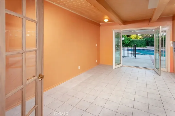 The dining area opens directly to the backyard through glass doors, creating an easy indoor-outdoor flow that is ideal for both everyday living and entertaining.