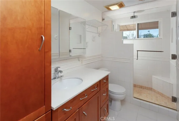 A nearby full bathroom with a tiled tub and shower combination adds convenience to this well-designed lower level.