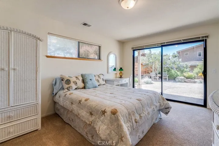 Downstairs second bedroom has a walk-in closet and sliding glass door to the sideyard.