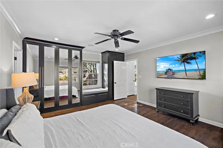 Primary bedroom with window seat and views to both the front and back yards.
