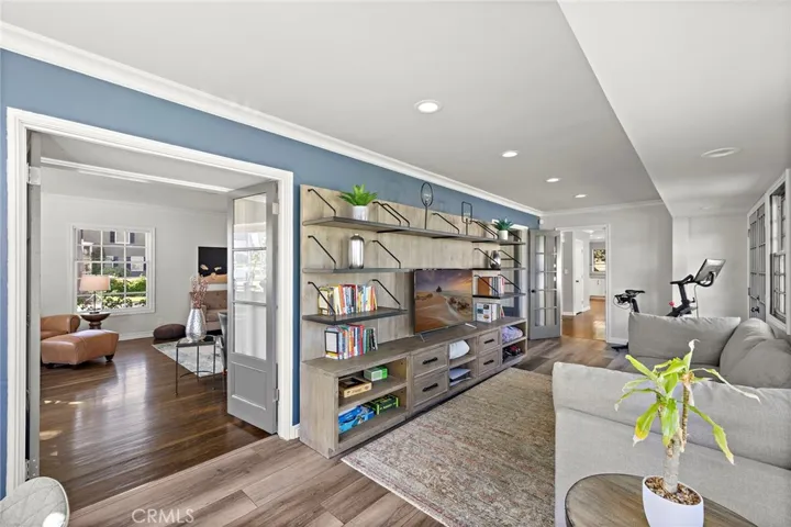 Enclosed sun room with beverage center and media area provides additional flex space
