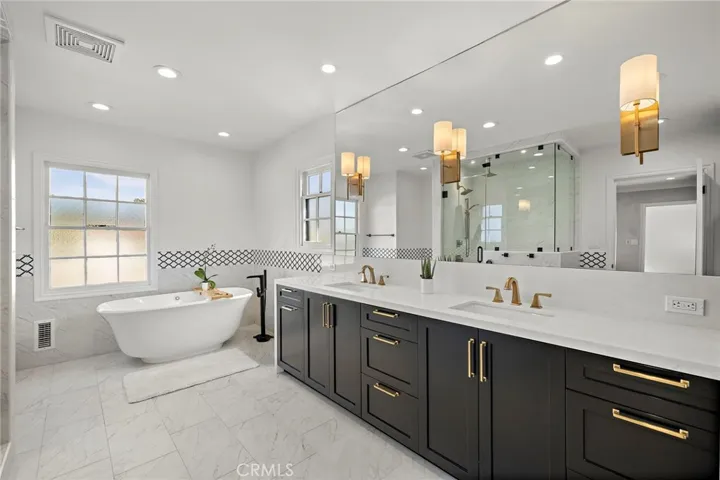 Gorgeous primary bathroom with dual sinks, soaking tub, and steam shower