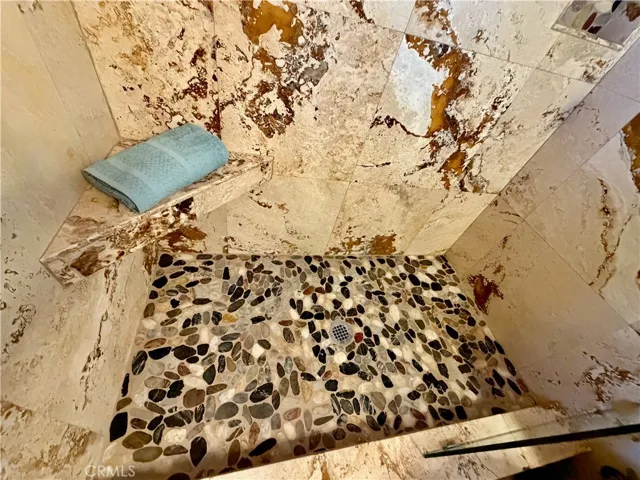 Pebble floor in walk in shower.