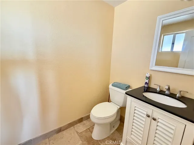Main floor bathroom with travertine tile flooring.