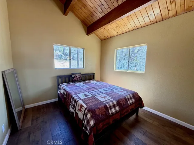 Top floor bedroom 1 with vaulted knotty pine ceiling.