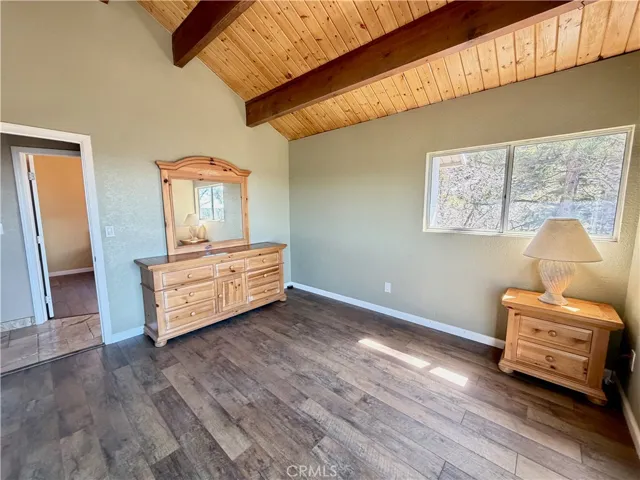 Top floor bedroom 2 with knotty pine ceiling and walk in closet.
