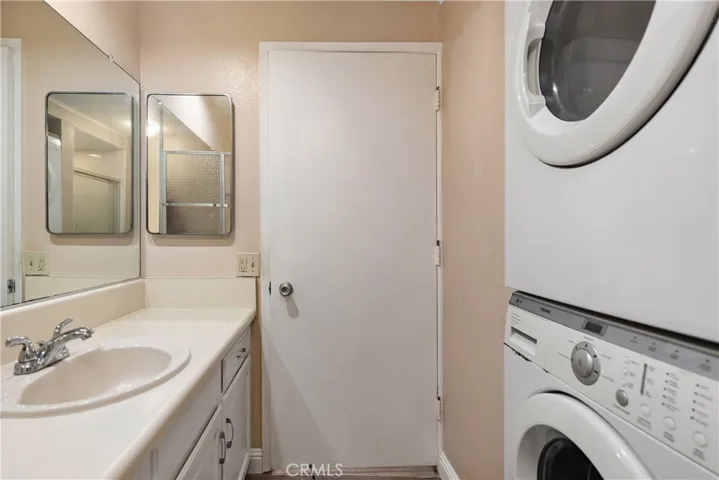 Secondary bathroom with stackable washer dryer
