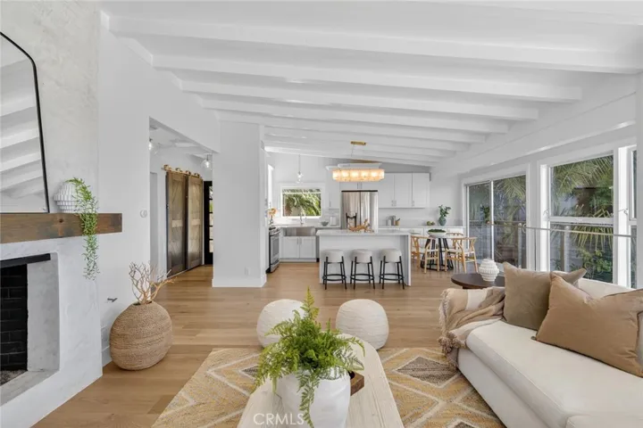 Living room with gas fireplace looking toward the open concept kitchen