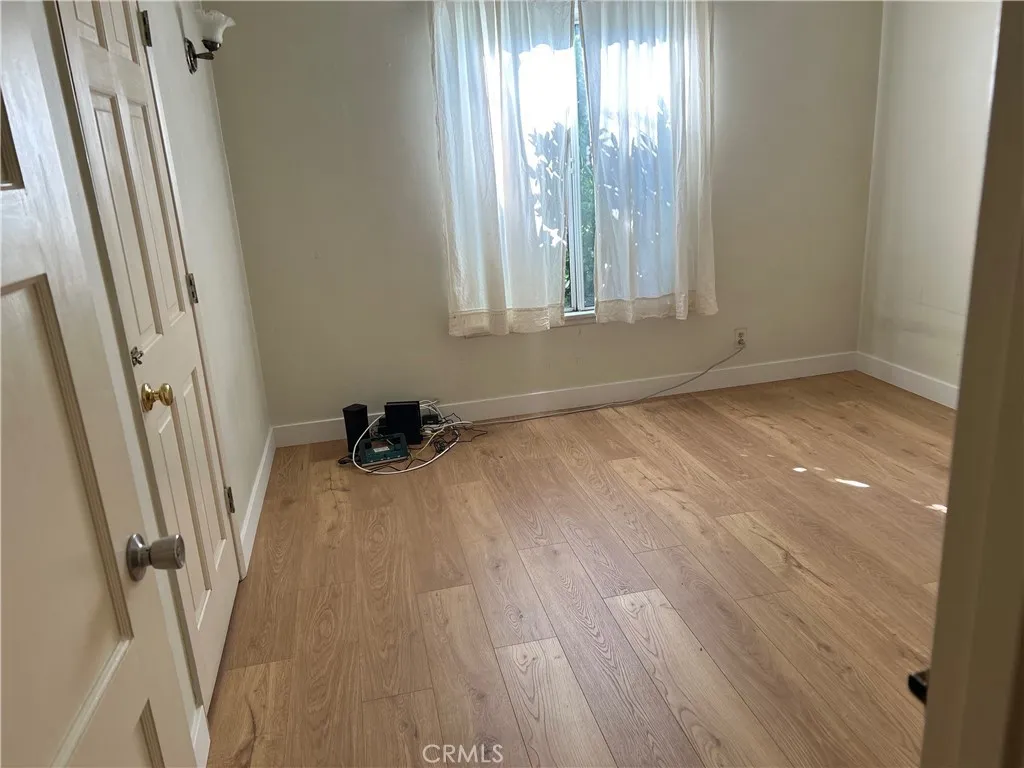 Second Bedroom with entry from the Hall       lway and view to the backyard.