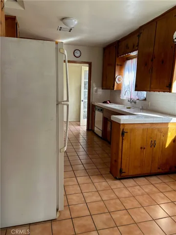 Kitchen Entry showing the refrigerator that included in Sale.