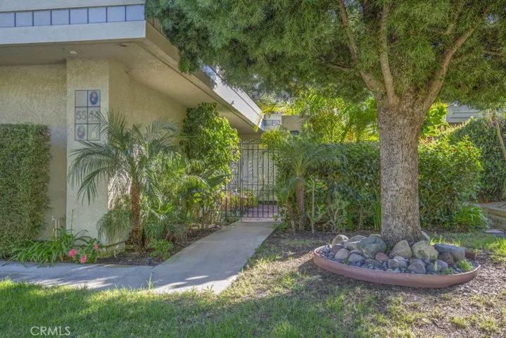 Walkway leading to the wrought iron front gate and private courtyard beyond.