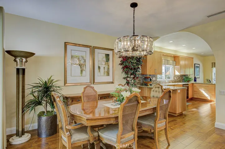 Large dining room easily accommodates a large dining table. Kitchen can be seen at right.
