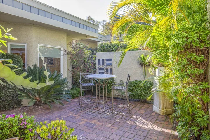 Another view of the front courtyard. The kitchen's breakfast nook has a lovely view of the courtyard through the windows at left.