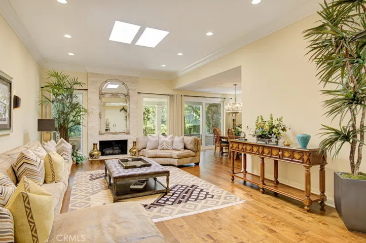 Another view of the living room. Note the wood-burning gas fireplace with attractive floor-to-ceiling stacked stone wall.