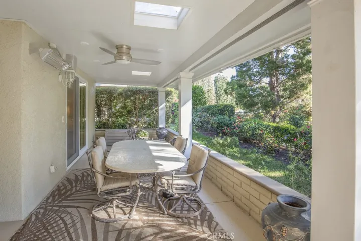 Covered rear patio has skylights, ceiling fan, recessed lighting and a heater.