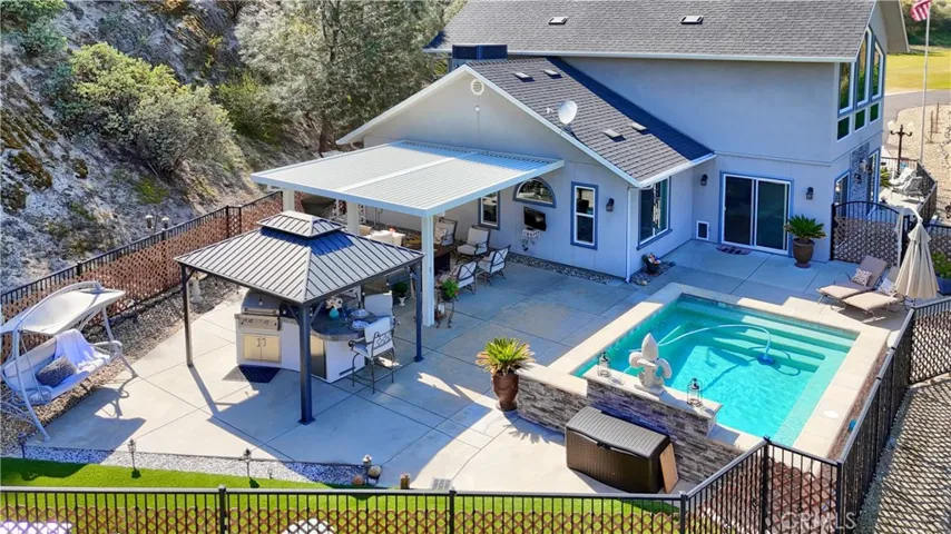 backyard aerial view, synthetic grass and concrete patio for low maintenance